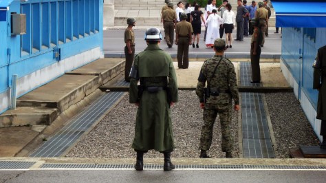 North Korean and South Korean soldiers dutifully guarding their respective sides of the border at the JSA.