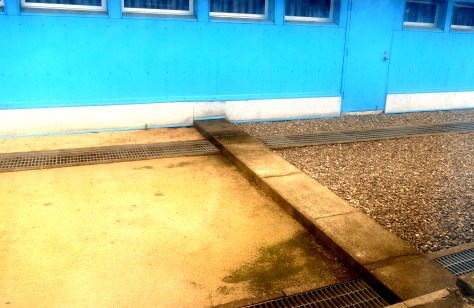 I peek out the window as I cross to the other side of the border. The smooth pavement at the left is North Korea; the textured one on the right is South Korea. It's still quite crazy to wrap my head around the fact that this is the only thing that is keeping the volatile stalemate.